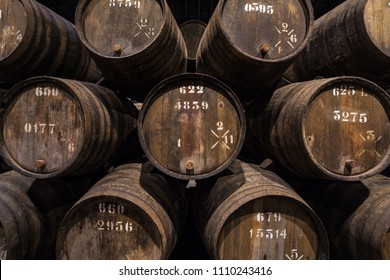 Row Of Wooden Porto Wine Barrels In Wine Cellar Porto, Portugal.