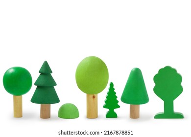 Row with wooden trees isolated on white background.
Children's wooden toys for creativity and skills development. Environmental protection concept. Montessori education.