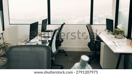 Row, workstation and desk with computer in office, programming department and setup in digital agency. Empty, interior and desktop by window at tech startup, furniture and coding team workplace