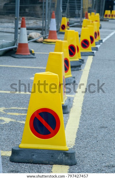 a row of\
yellow cones with a \