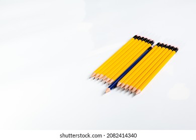 Row Of Yellow Sharpened Pencils With One Blue Different Pencil Not Aligned With The Other Pencils