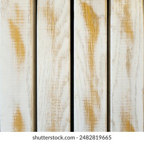 A row of yellowish wood planks painted white and peeling, rubbed, faded, from a fault. Surface for commercial photography of raw, vintage products, good for wrapping 3D models. Free space for text.