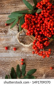 rowan berries on wooden background - Shutterstock ID 1491709370