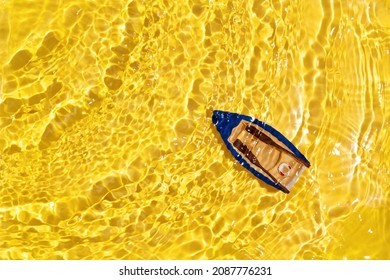 Rowboat on yellow water background. Summer vacation concept