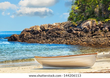 Rowboat pulled ashore onto the sandy beach of a secluded island