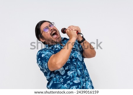 A rowdy and possibly drunk middle aged tourist shouting into the microphone during a fun karaoke night.