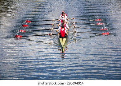 Rowers in eight-oar rowing boats on the tranquil lake - Shutterstock ID 220694014