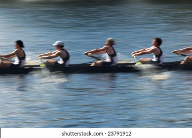 Rowers in a rowing boat pulling in harmony, motion blurred to accent speed - Powered by Shutterstock