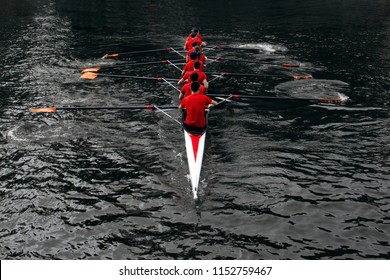 Rowers Rowing In The Dark Water. The Concept Of Team Sports