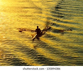 Rowing alone at sunset - Powered by Shutterstock