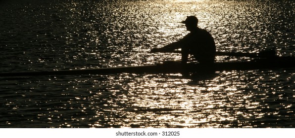 Rowing alone at sunset