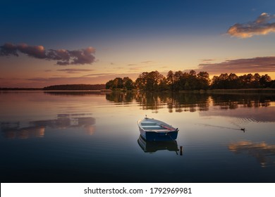 Rowing boat floating over the Elckie Lake waters. Masuria, Poland.