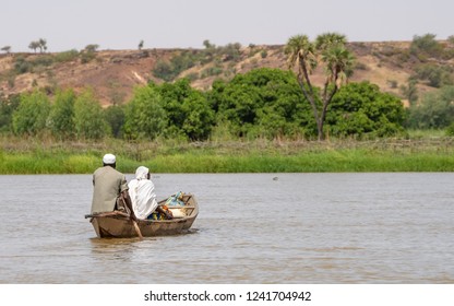 Rowing a boat on the Niger River in Sahara, Sahel. West-Africa Travel in Niger Niamey on the Niger River.