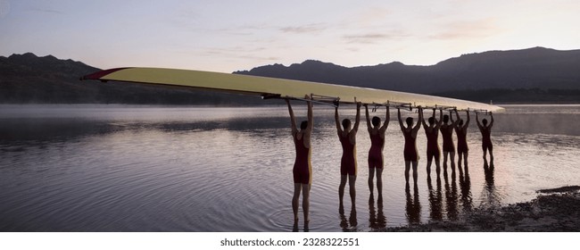 Rowing crew holding scull overhead in lake - Powered by Shutterstock