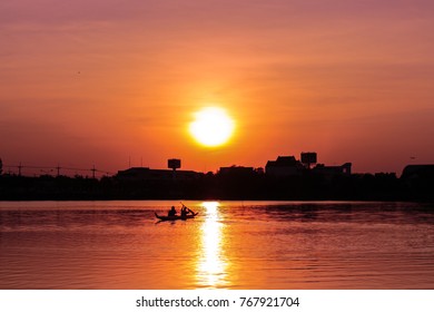 Rowing kayak in sunset