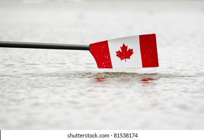 Rowing Oar And Blade In The Colors Of Canada, Hovering Just Above The Water