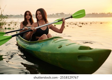 Rowing with oars. Women friends are on sup board on the lake together. - Powered by Shutterstock