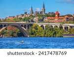 Rowing Potomac River Key Bridge Georgetown University Washington DC from Roosevelt Island.  Completed in 1923 this is the oldest bridge in Washington DC.