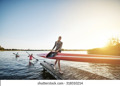 Rowing team after training getting out of the water - Powered by Shutterstock