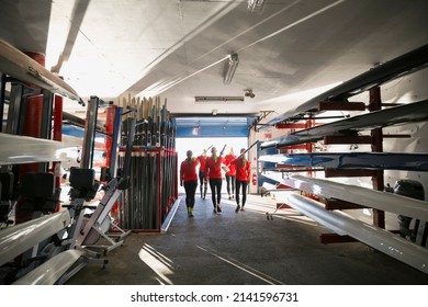 Rowing team carrying oars in boathouse - Powered by Shutterstock