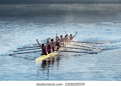 Rowing team celebrating in scull on lake - Shutterstock ID 2328320559