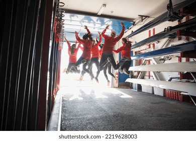 Rowing team jumping for joy in boathouse - Powered by Shutterstock