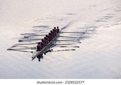 Rowing team rowing scull on lake - Powered by Shutterstock