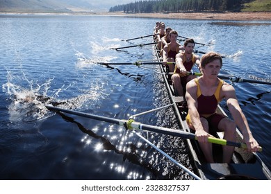 Rowing team rowing scull on lake - Powered by Shutterstock