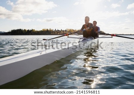Rowing team in scull on river
