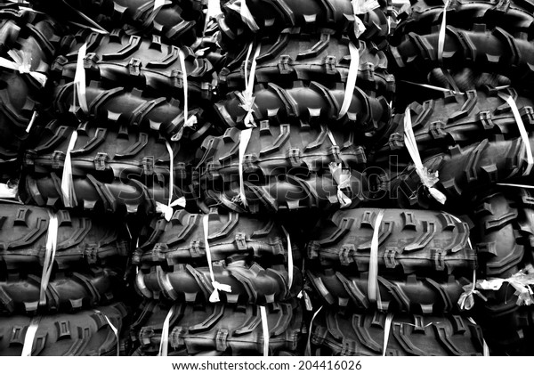 Rows of black tires with\
white ropes 