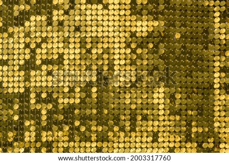 rows of blinking golden yellow brass metal plaques sway in wind and shines in sun and create unique pattern of movement. round reflective particles texture glitter under waves of wind. Spangle Glitter