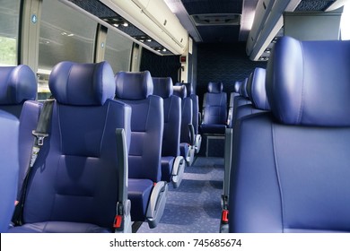 Rows of blue leather seats inside the bus