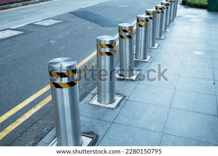 
Rows of bollards are located at the edge of the sidewalk next to the road. each Stainless Steel bollard has a reflective tape