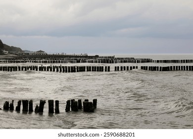 Rows of breakwaters driven into the seabed protect the coast from the damaging effects of waves on the Baltic Sea coast as seen from Ustronie Morskie, Poland.
