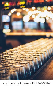 Rows Of Clean Empty  Beer Or Water  Glasses Turn Upside Down On Counter Bar
With Bokeh Background