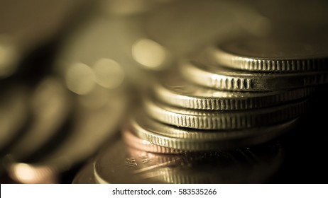 rows of coins in blurred style for finance and business concept