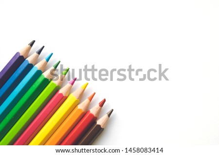 Rows of Color pencils on white paper background, copy space. Office supplies, back to school.