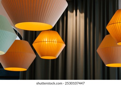 Rows of colorful glowing orange lanterns. Modern warm lamp. Minimalist design. Urban style interior lighting. Actual decoration. - Powered by Shutterstock