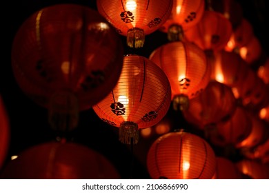 Rows of colorful glowing red Chinese lanterns
