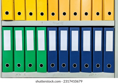 rows of colorful ordner neatly arranged in an office supply store - Shutterstock ID 2317410679