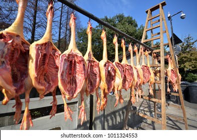 Rows Of Cured Meat Hanging To Dry In A Rural Market In China