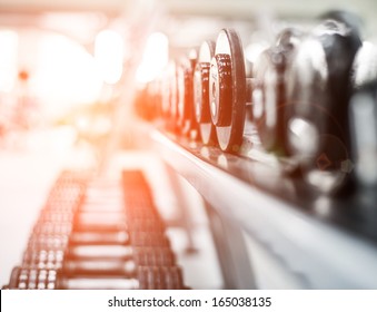 Rows of dumbbells in the gym - Shutterstock ID 165038135