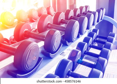 Rows of dumbbells in the gym with color filters