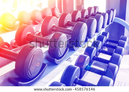 Rows of dumbbells in the gym with color filters