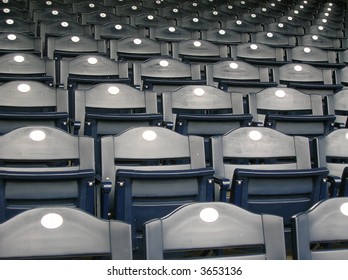 Rows of empty blue seats.