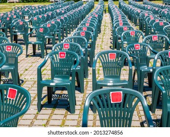 Rows of empty green plastic chairs in Roses Park, Timisoara. Chairs for  outdoor concerts, festivals and other events.