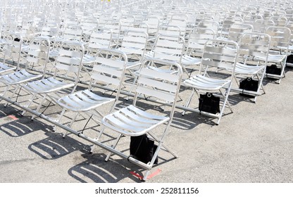 Rows of empty metal chair seats installed for some business event or performance,festival - Powered by Shutterstock