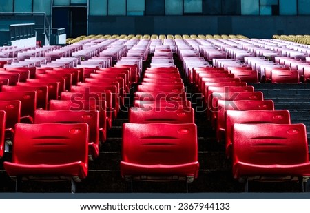 Rows of empty red seats in auditorium