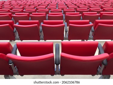 Rows of empty red seats in the stadium.