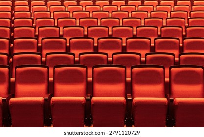 Rows of empty red seats in a theater auditorium